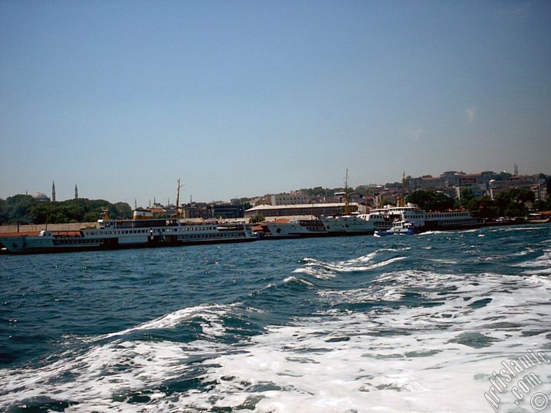 View of Eminonu coast, ships and Ayasofya Mosque (Hagia Sophia) from the sea in Istanbul city of Turkey.
