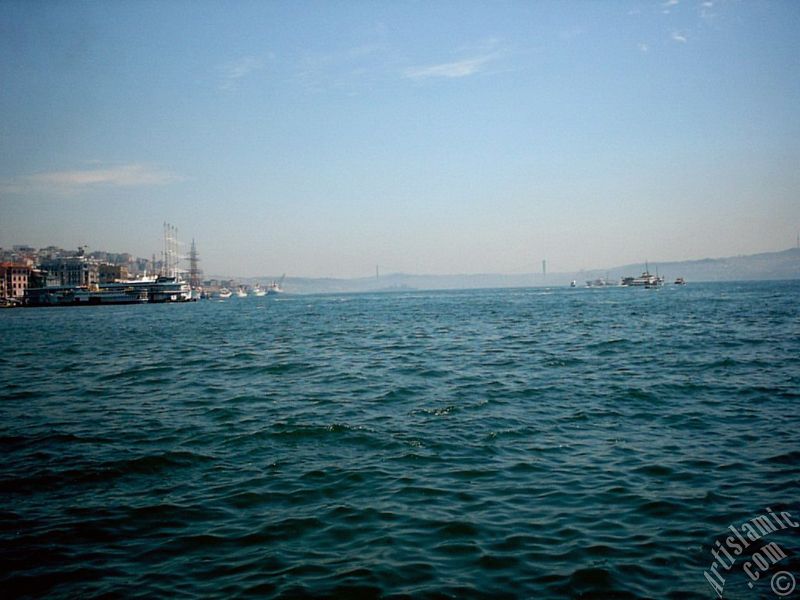 View towards Bosphorus, on the left Karakoy shore and on the horizon the Bosphorus Bridge from under Galata Bridge located in Istanbul city of Turkey.
