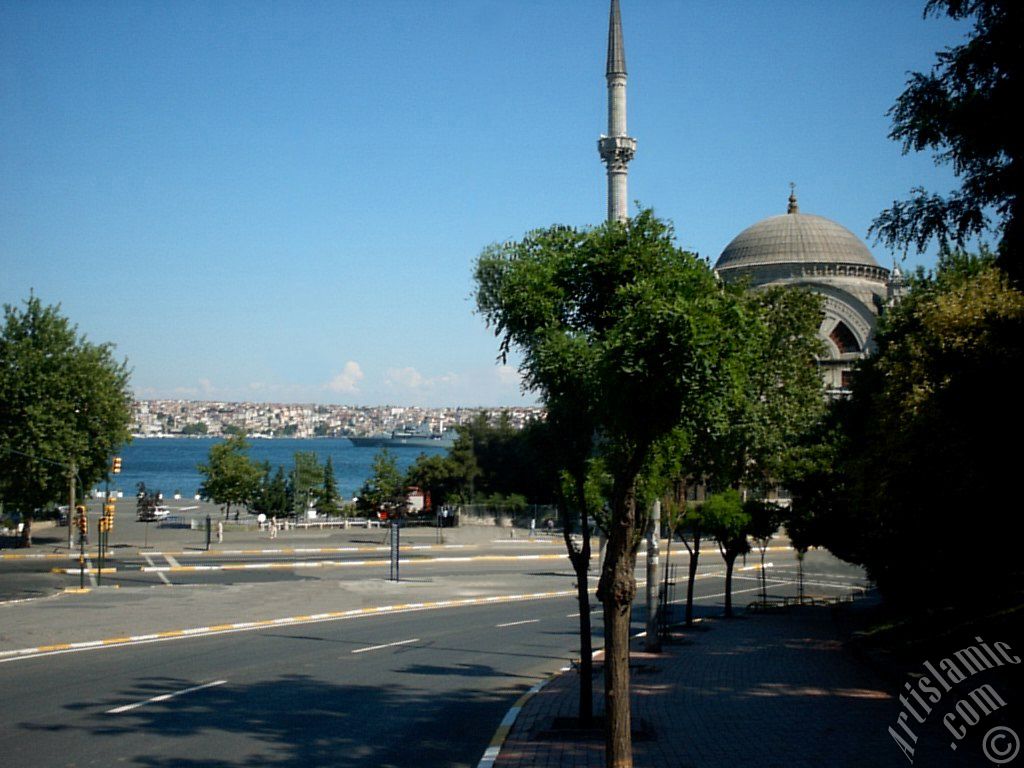 View of Dolmabahce coast and Valide Sultan Mosque in Dolmabahce district in Istanbul city of Turkey.
