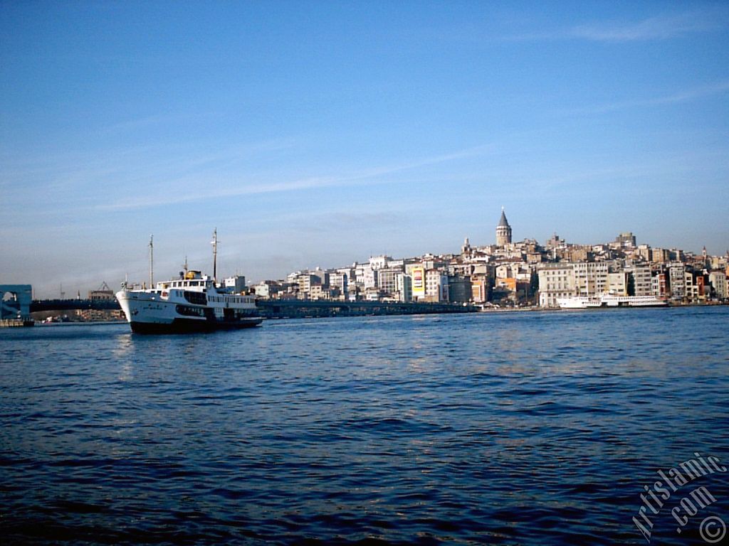 View of a landing ship, Galata Bridge and Galata Tower from the shore of Eminonu in Istanbul city of Turkey.
